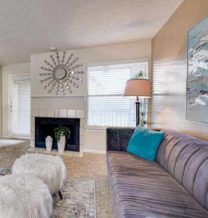 A living room with a fireplace, a couch, and a television.