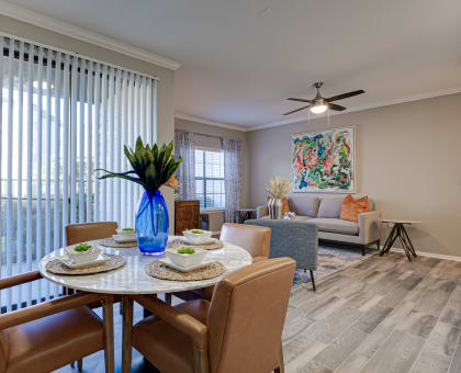 an open living room and dining room with a table and chairs at Carmel Creekside Apartments, Fort Worth, 76137