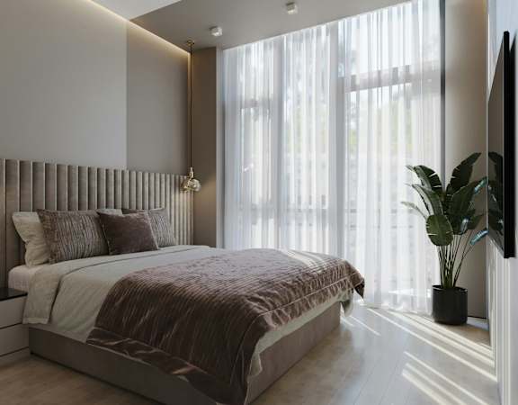 A modern bedroom with a large bed and a flat screen TV.