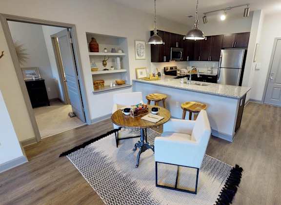 a kitchen and dining area with a table and chairs