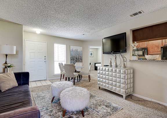 a living room with a fireplace and a flat screen tv
