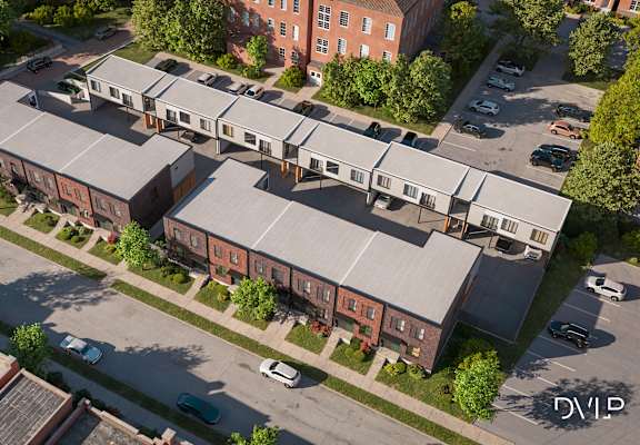 An aerial view of a building with a parking lot in front.