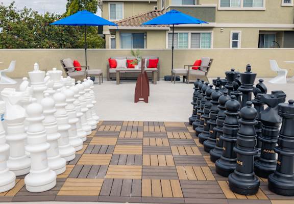 Giant chess set on a wooden board.