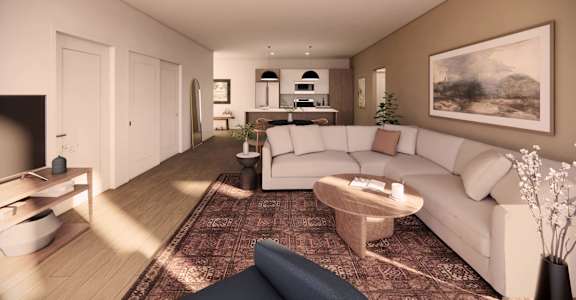 A living room with a white couch and a coffee table.