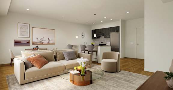 a living room and kitchen with a couch and chairs