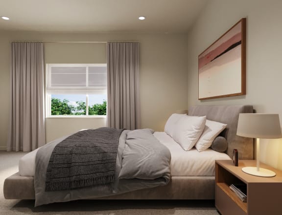 the master bedroom has a large bed and a large window