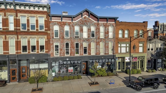 a large brick building on the corner of a city street at The Granite Works Apartments , Buffalo, 14202