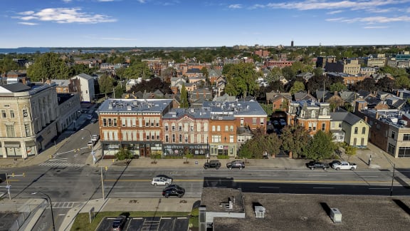 an aerial view of a city with buildings and cars on a street at The Granite Works Apartments , Buffalo, NY