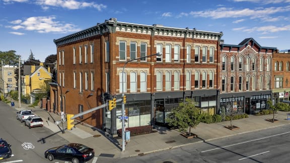 a large brick building on the corner of a city street at The Granite Works Apartments , Buffalo, 14202