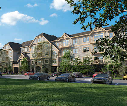 A row of houses with cars parked in front.