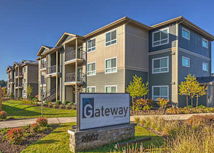 A large building with a sign that says Gateway in front of it at GATEWAY BY VINTAGE, Spanaway, WA, 98387