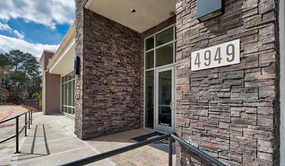 a building with a glass door and a sign that reads 4949