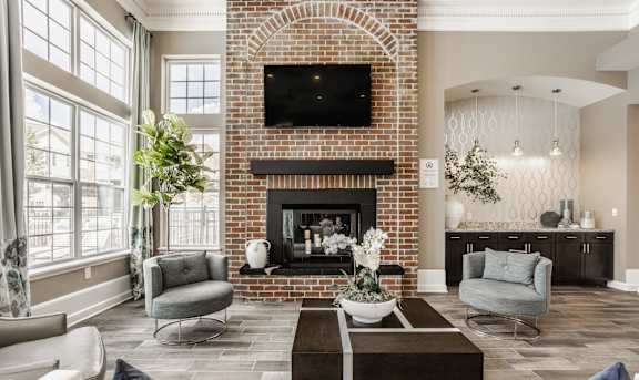 A living room with a fireplace and a television above it.