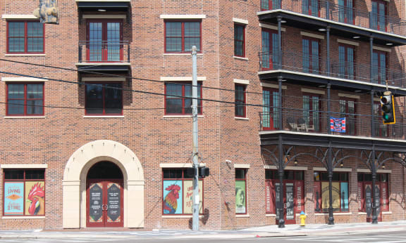 a rendering of people walking on a sidewalk in front of apartment buildings at Casa Marti, Tampa, FL