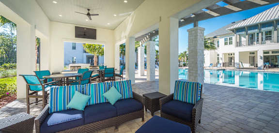 Patio with Couches and Chairs at Alaqua Apartments, Jacksonville, FL 32258