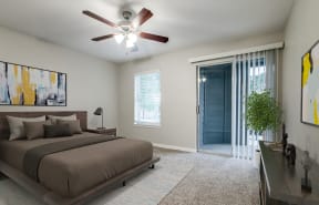 the master bedroom has a comfy bed and a ceiling fan