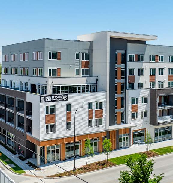 A modern multi-story building with a mix of grey and brown exterior walls. at Railside at Wadsworth Station, Colorado