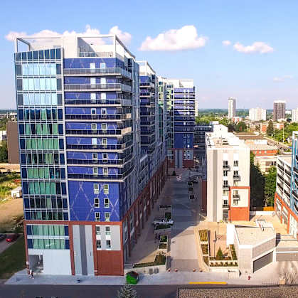 A modern building complex with blue and white glass windows.