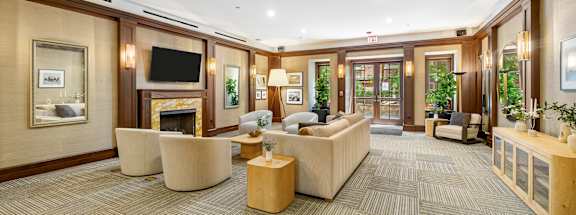 a living room with couches and chairs and a fireplace at HIGHGROVE, Stamford, Connecticut