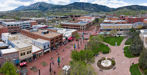 A town square with a fountain in the middle of it.