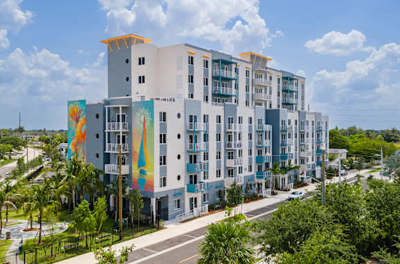 A modern multi-story building with a mural on the side.