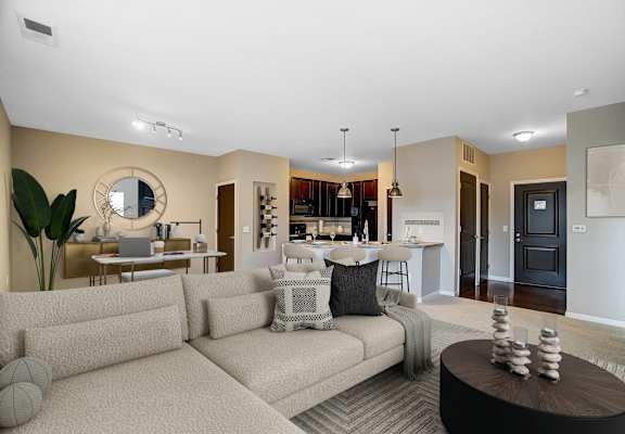 A living room with a couch, coffee table, and a mirror on the wall.