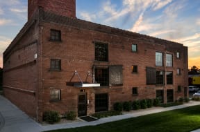 an old brick building with a piano hanging out of the window