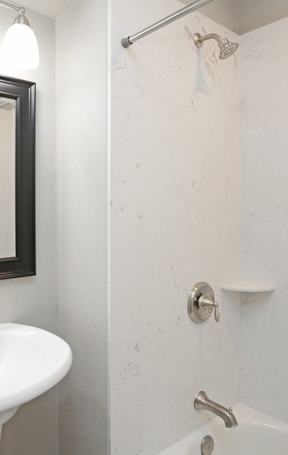 bathroom with pedestal sink and marble shower