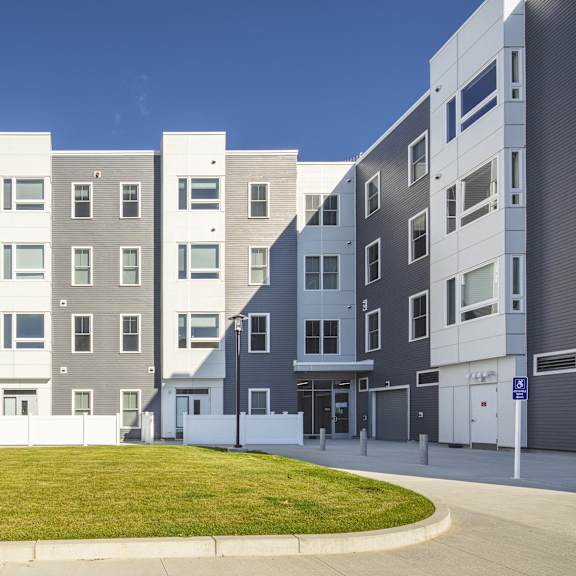 a rendering of an apartment building on a city street at The Anne M. Lynch Homes at Old Colony, Massachusetts, 02127