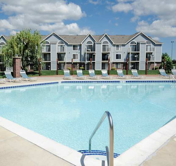 Woman with a child in the swimming pool at Huntington Cove Apartments, 46410