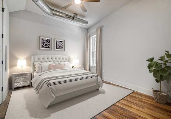a white bedroom with a white bed and a white rug