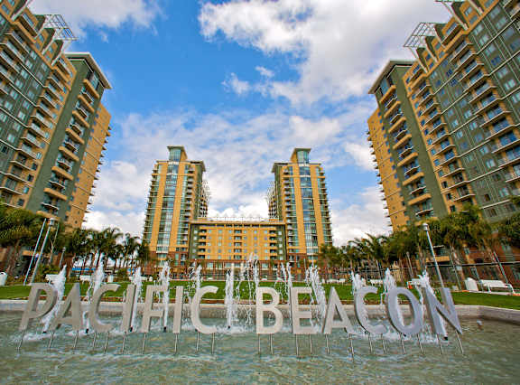 A fountain in front of a sign that says Pacific Beach.