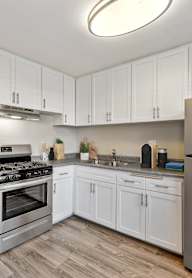 the preserve at ballantyne commons community room with counter and refrigerator and bulletin board at Sunnymead Apts Apartments, Moreno Valley, California