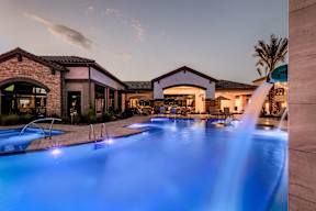 a swimming pool with blue water at night