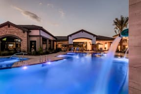 a swimming pool with blue water at night
