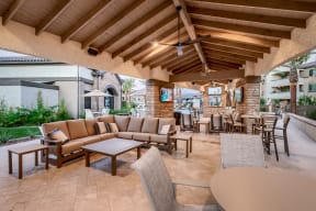 a patio with couches and tables and chairs