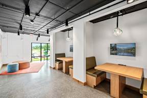 A room with a long table and chairs.