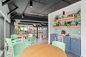 A modern kitchen with a dining table and chairs.