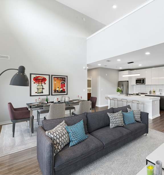 A modern living room with a grey couch and a coffee table.