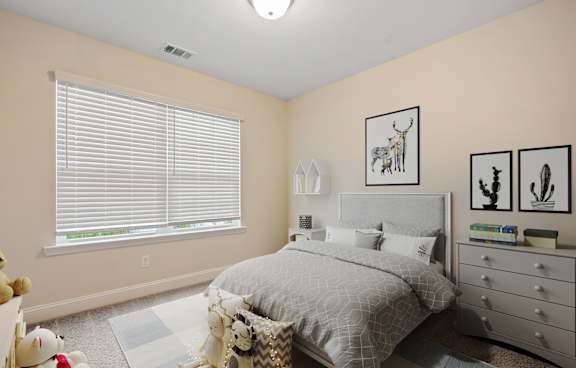 A bedroom with a bed, dresser, and window with blinds.
