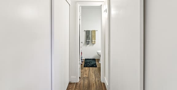 A hallway with a mirror on the wall.