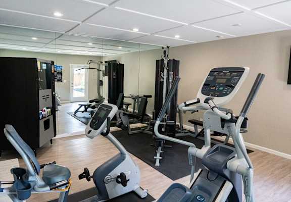 a gym with cardio machines and other exercise equipment