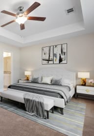 a bedroom with a bed and a ceiling fan