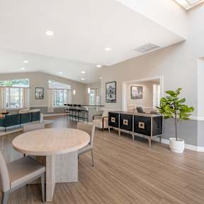 A spacious living room with a large round table and chairs. at The Apartments at Elmwood Terrace, Frederick, MD
