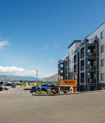 a view of a street with new apartment buildings on either side