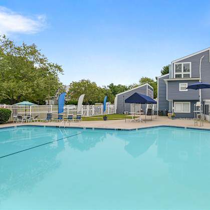 A large swimming pool in front of a building.