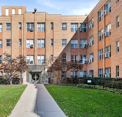 A long building with a walkway in front.
