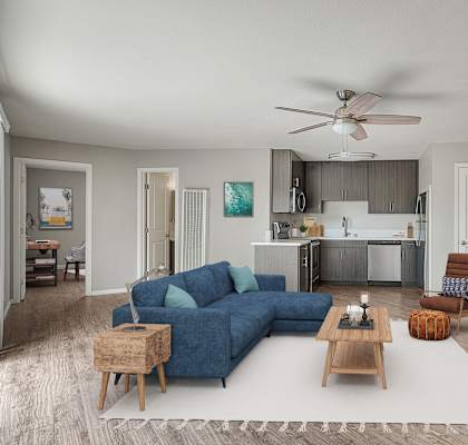 A living room with a blue couch and a wooden coffee table.