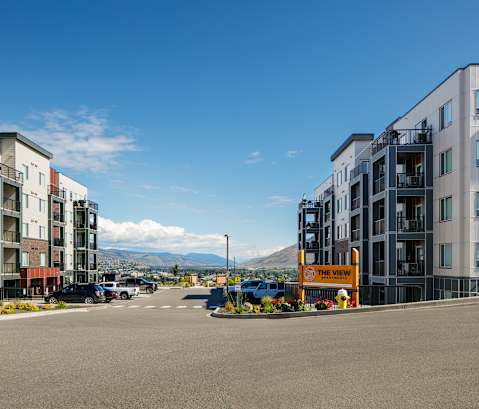 a view of a street with new apartment buildings on either side