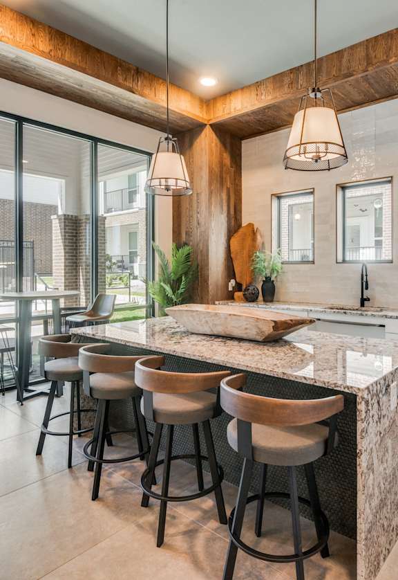 A modern kitchen with a bar area and a dining table.